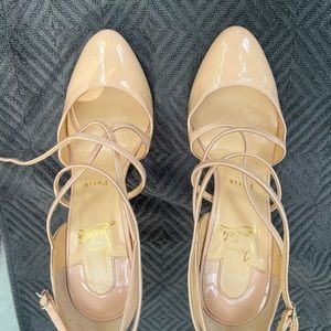 Christian Louboutin nude patent leather strappy heels.